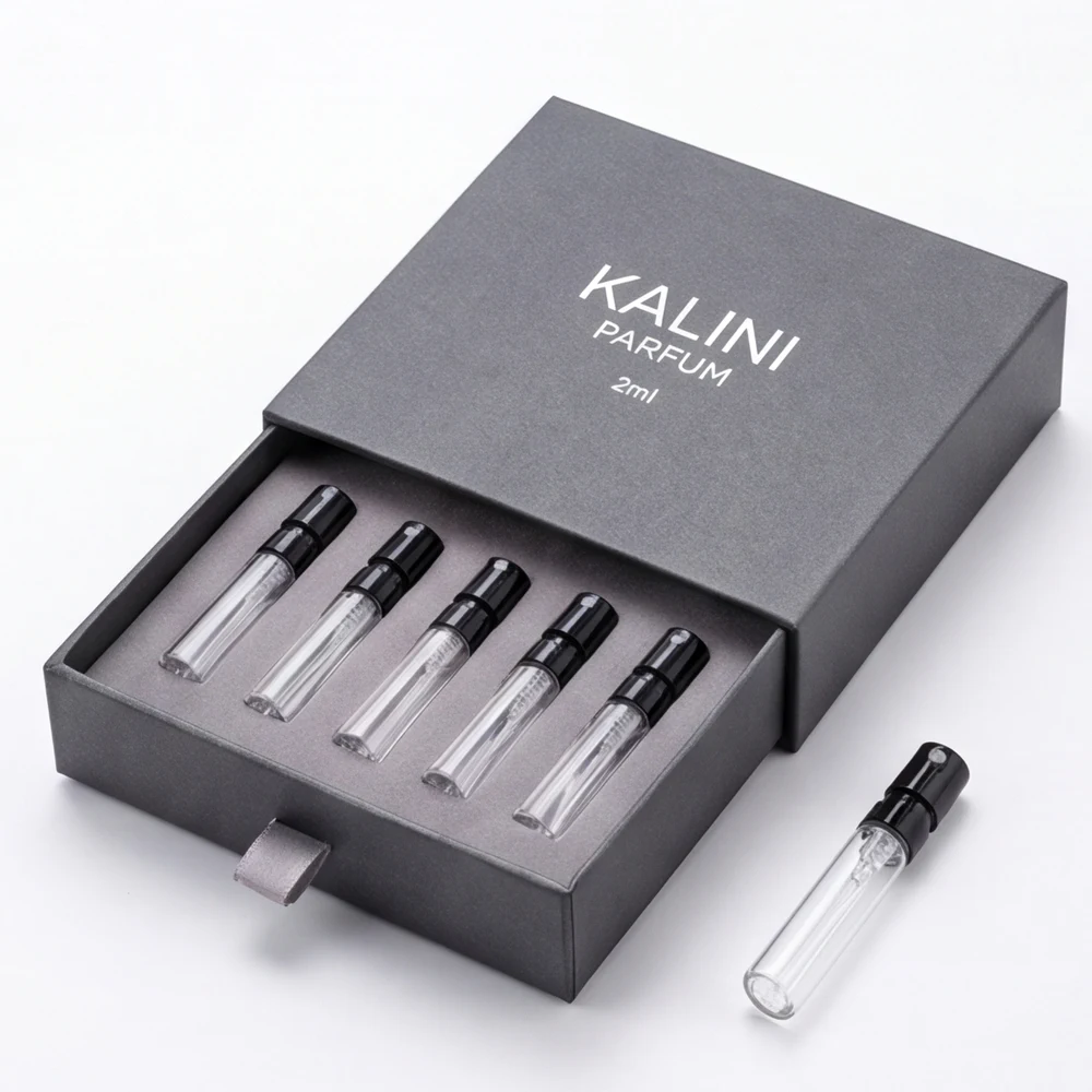 Five perfume sample vials in a gray drawer presentation box